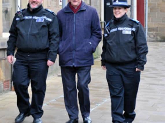 Dr Alan Billings on walkabout with police officers.