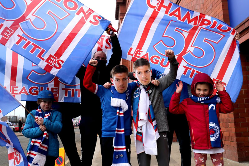 Rangers fans celebrate outside the Ibrox Stadium after Rangers win the Scottish Premiership title.