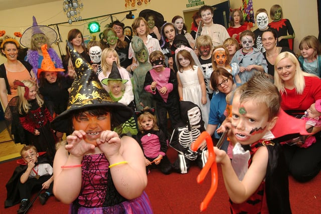 Youngsters and their carers get all spooky in their Halloween costumes during a daytime Myths and Magic disco for the Elkesley Raod Play Scheme in Meden Vale in 2009