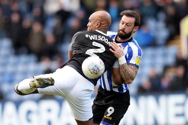 Steven Fletcher gets to grips with Derby County defender Andre Wisdom.
