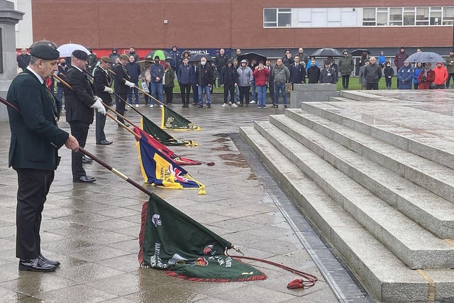 Standards are lowered during the service at Victory Square.