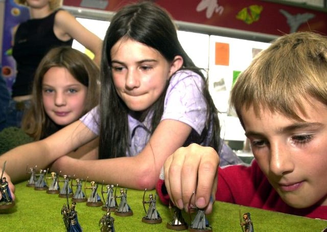Sara Brautigam, Alison Macguire, Jerry Macguire playing a fantasy war game in Central Doncaster Library, 2002.