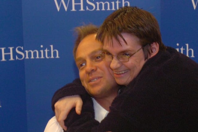 Jason Donovan pictured at his book signing at WH Smith, Meadowhall. One fan gives him a hug