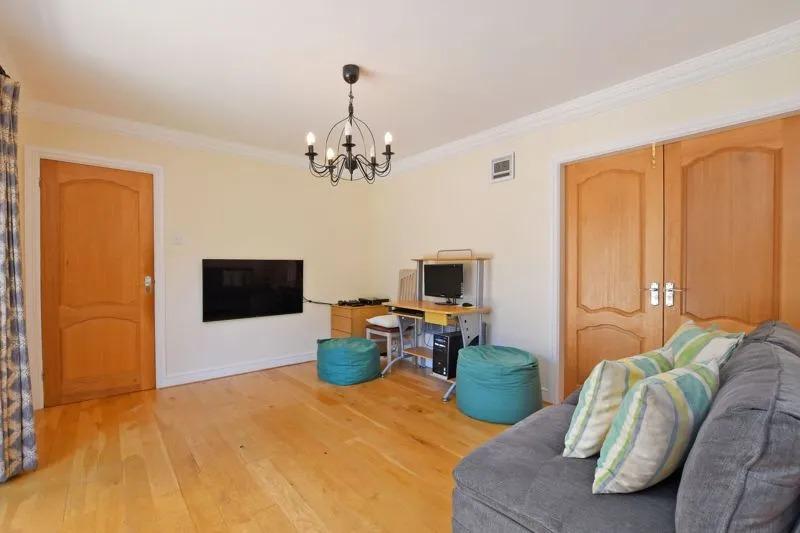 The wooden floor and doors create a cosy feel in this space which offers plenty of room.