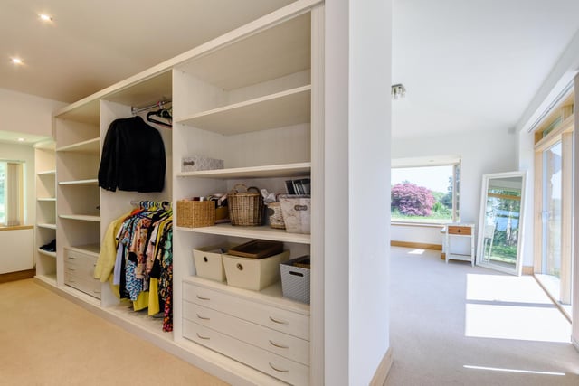 The master dressing area with bespoke fitted shelves and drawers. The master suite is located just off the living area also includes a lounge area that could also make an ideal nursery and ensuite.
