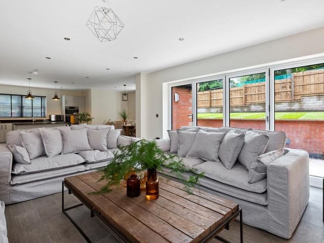 Here is the stylish living room that is part of the open-plan hub of the house. Bright and airy with easy access to the garden.