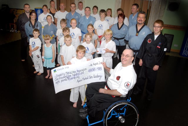 In 2009  Apex Martial Arts group presented £1108 to David Lee of the Disability Martial Arts Association pic shows Lewis Walvin handing over the cheque and other members of the group