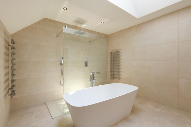 This is the first bedroom's en-suite, with a glorious freestanding tub as its centrepiece.
