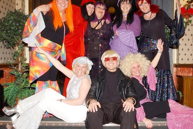Brenda Boardman, Joanne Holland, Sharon Saywell, Tracy Hithersay, Julie Wragg, Tracey Naylor, David Markham and Jane Uttley pictured at the 70's charity night held at the Niagara Club in 2003
