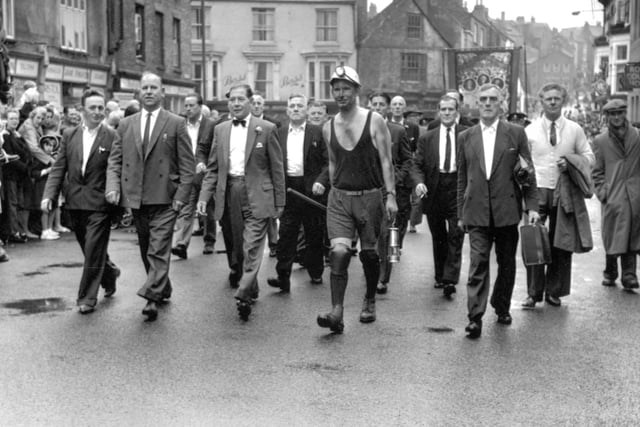 The crowds make their way through the city towards the Racecourse for the 1964 Miners' Gala celebrations which were eventually abandoned because of a thunderstorm.