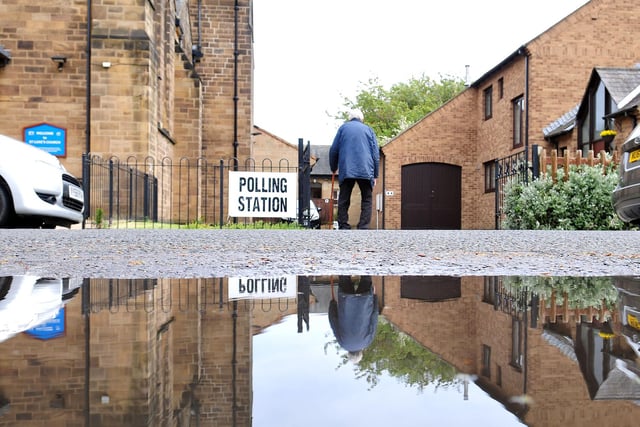 A voter makes his way into St. Luke's Church Hall to cast his vote in the 2014 elections.