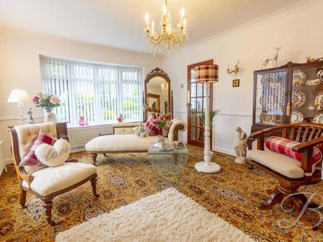 The living room can only be described as beautiful. It boasts a carpeted floor, feature fireplace, central-heating radiator and bay window to the front of the property, with a second window to the side.