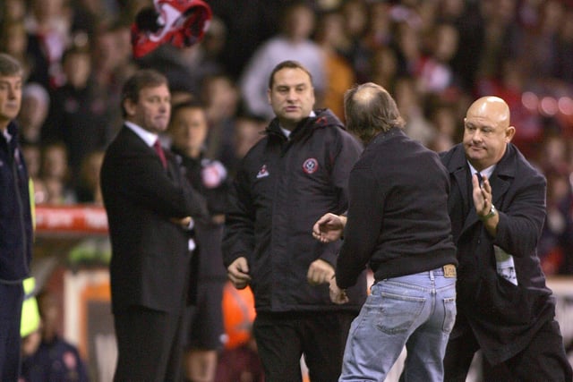 A Blades fan ran onto the pitch and threw his scarf at manager Bryan Robson