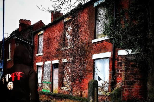 Urban explorer Lost Places & Forgotten Faces outside the boarded-up and derelict properties on Chatsworth Road, near The Tap House pub.