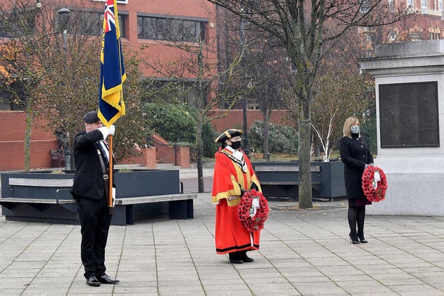 Standard Bearer Andrew Barker, The Mayor of Hartlepool Councillor Brenda Loynes and managing director of Hartlepool Borough Council Denise McGuckin line up in front of the war memorial.