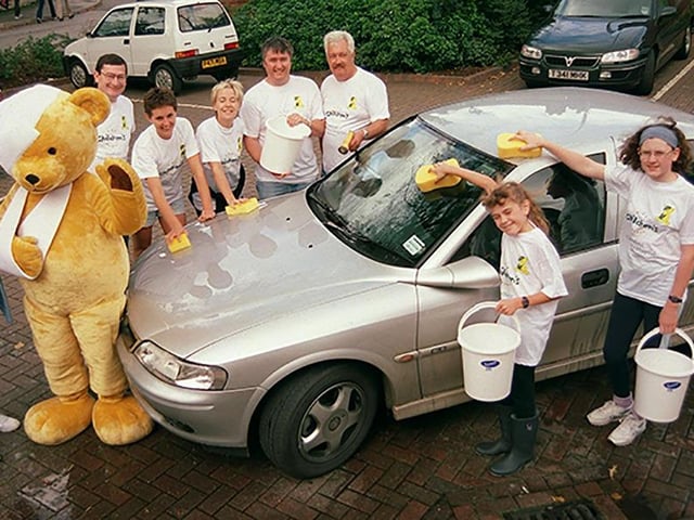 Jenny and Christine Lees, right aged 10 and 12, get a helping hand from Theo the Children's Hospital bear at the charity car wash at the Aunty Sally pub, Clarkehouse Road, in aid of the Children's Hospital, on August 25, 1999