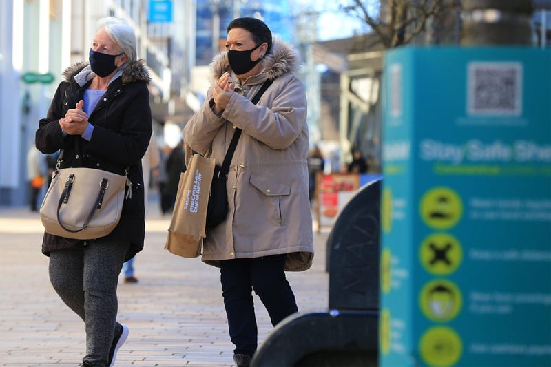 Shoppers in masks on The Moor, Sheffield making use of hand sanitiser. Non-essential shops reopened on Monday, April 12 as lockdown restrictions are eased