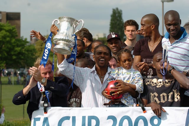Nwankwo Kanu scored the winner, so it was no surprise he looked so happy with the FA Cup. Players and their families enjoy the moment. Picture: Malcolm Wells 082235-201