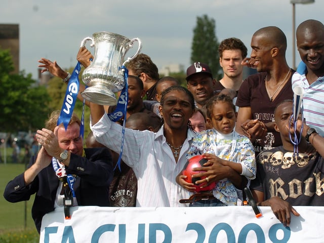 Nwankwo Kanu scored the winner, so it was no surprise he looked so happy with the FA Cup. Players and their families enjoy the moment. Picture: Malcolm Wells 082235-201