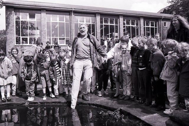 David Bellamy entertains the children at Lydgate First School, Crosspool, when he dropped by to open the new mini wildlife garden, June 13, 1991