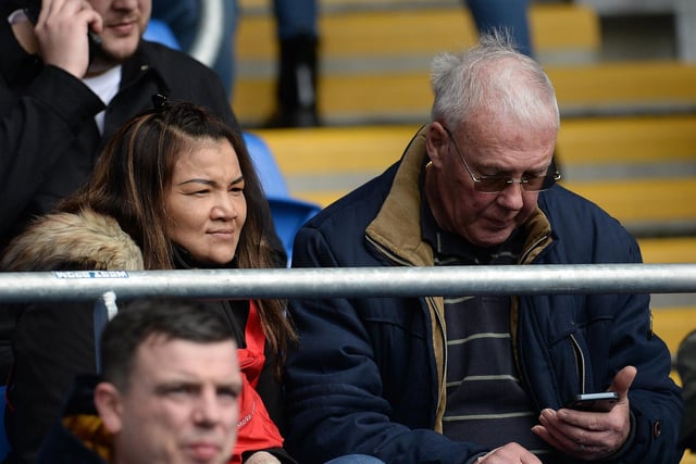 A North End fan on his phone pre-match