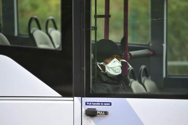 A passenger wearing a face mask as a precaution is seen on a bus in northern England (Photo by Oli SCARFF / AFP) (Photo by OLI SCARFF/AFP via Getty Images)