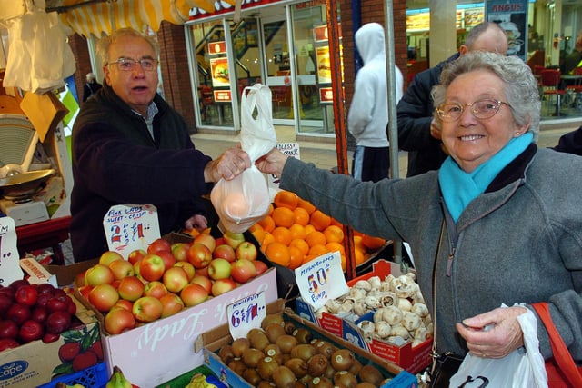 Market traders now placed in Commercial Road Portsmouth. 'Tricky' Walker (74) serving a customer. Picture: Malcolm Wells (070151-33)