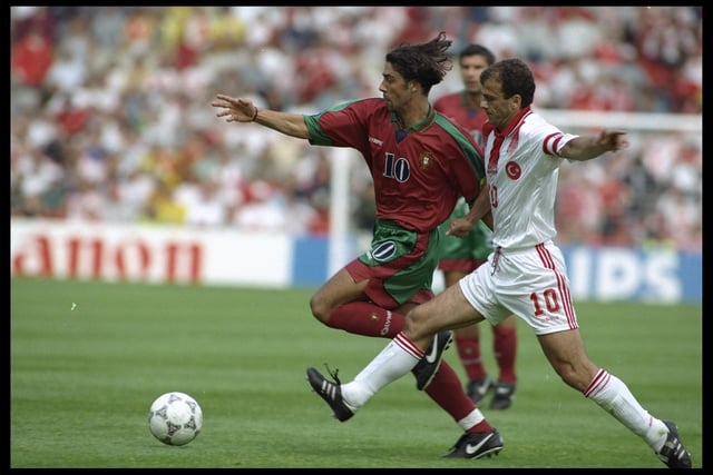 Rui Costa of Portugal is challenged by Oguz Cetin of Turkey in their Group D match.