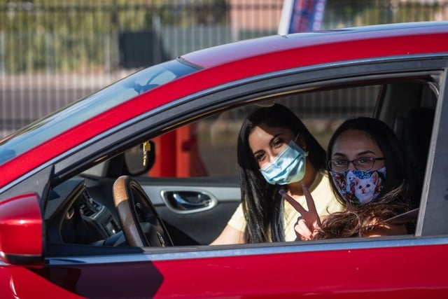 Amanda Franco, 19, and Danielle Franco, 25, pose while waiting to vote by express curbside voting at the El Paso County Coliseum, in El Paso, Texas.