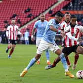 Manchester City's Riyad Mahrez (left) and Sheffield United's Max Lowe battle for the ball: Tim Keeton/PA Wire