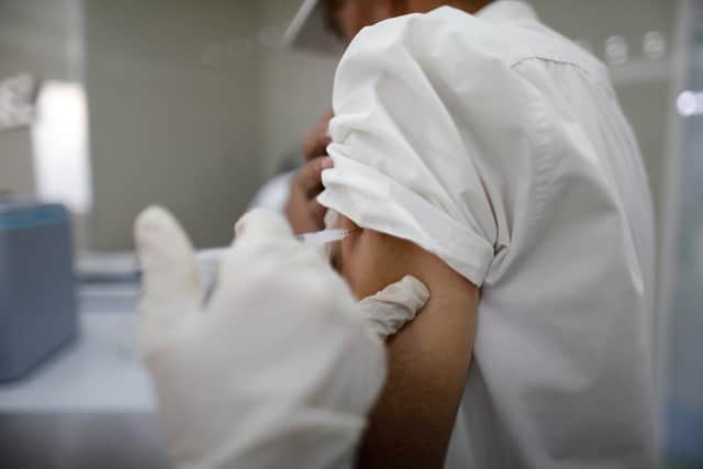 A person is vaccinated (Photo by Leonardo Fernandez Viloria/Getty Images)