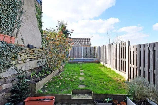 Outside, there is a planted forecourt, a shared passageway, and an enclosed, end of row, west facing lawned rear garden with planted borders, fencing, and a block-paved terrace.