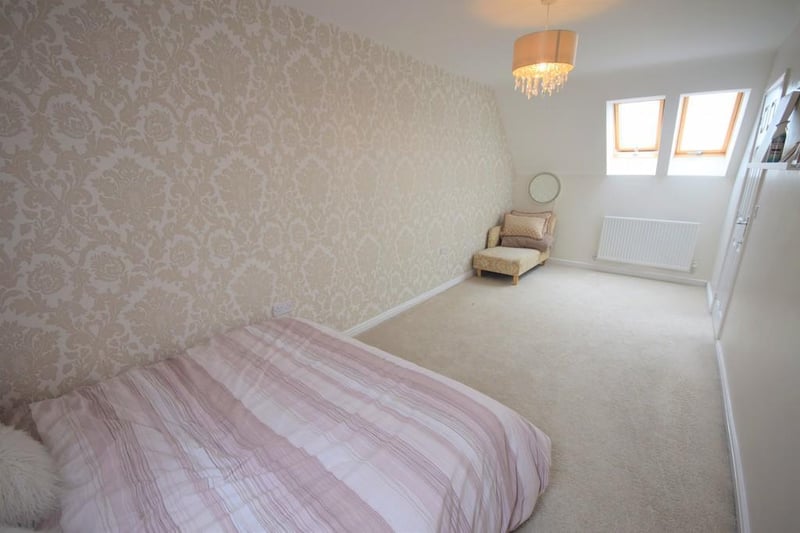 A generously sized double bedroom having a radiator, loft access, Velux window to the rear and two to the front.