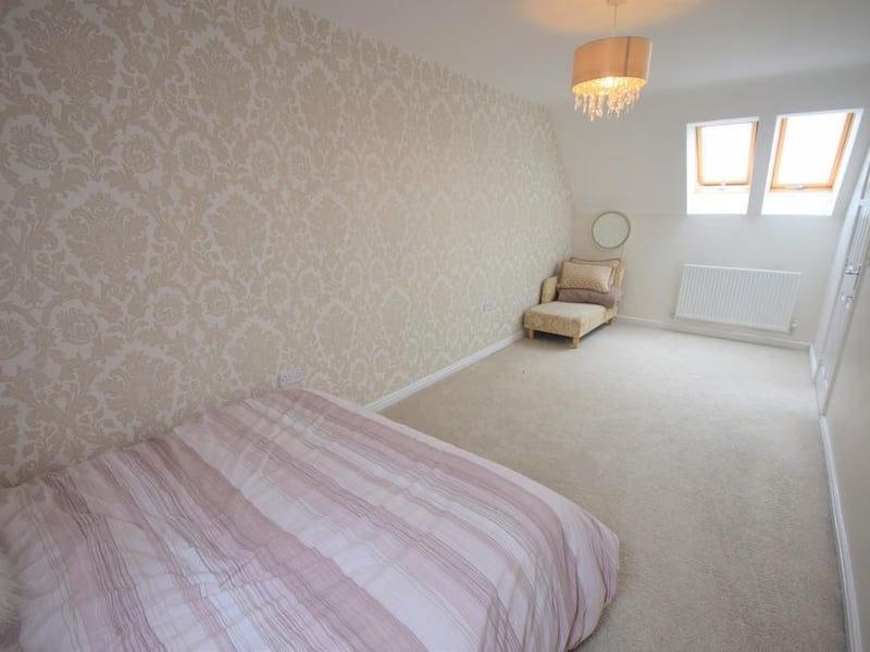 A generously sized double bedroom having a radiator, loft access, Velux window to the rear and two to the front.