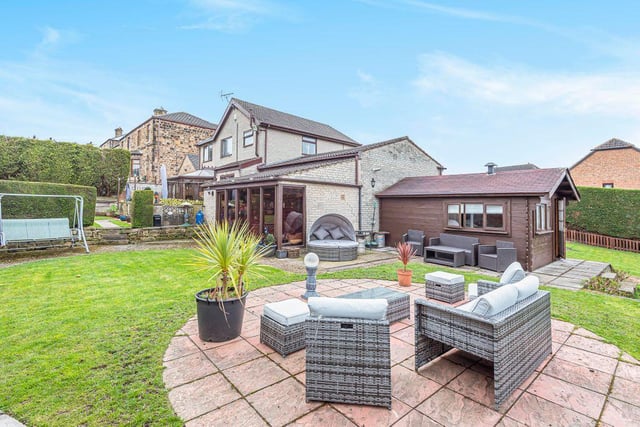 Outside there is a gated front garden with a large driveway, and to the rear a patio and a landscaped garden spread over three levels, which extends to the side of the property.