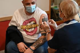 A man receives a dose of the Pfizer Covid-19 vaccine in a vaccination clinic set up at St Columba's Church in Sheffield on December 15, 2021 as the UK steps up the country's booster drive to fight a "tidal wave" of Omicron. - The country's medical advisers have raised the Covid Alert Level due to a "rapid increase" in infection from the variant. (Photo by Oli SCARFF / AFP) (Photo by OLI SCARFF/AFP via Getty Images)