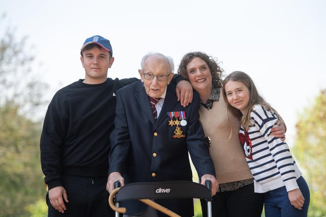 Sir Tom poses with (left to right) grandson Benji, daughter Hannah Ingram-Moore and granddaughter Georgia, at his home in Marston Moretaine, Bedfordshire.
