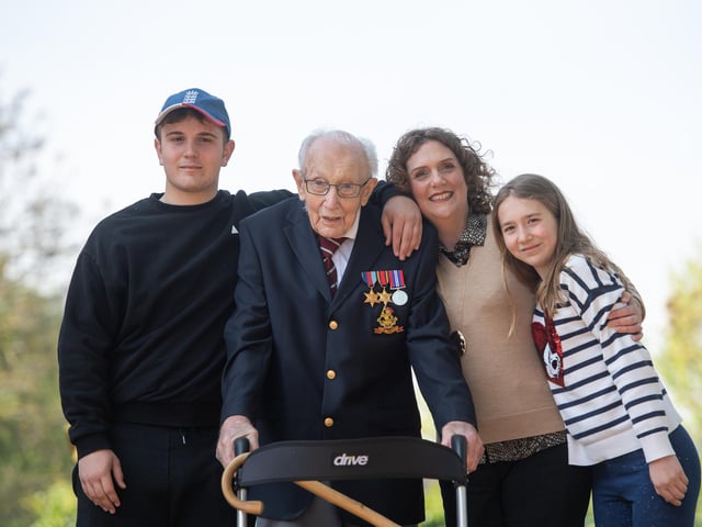 Sir Tom poses with (left to right) grandson Benji, daughter Hannah Ingram-Moore and granddaughter Georgia, at his home in Marston Moretaine, Bedfordshire.