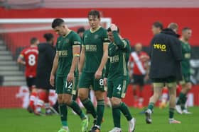 Sheffield United's John Egan, Sander Berge and John Fleck leave the pitch disappointed during the Premier League match at St Mary's Stadium, Southampton.   David Klein/Sportimage