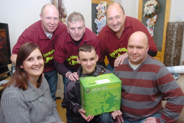 Daniel Andrewatha, 14, of Poplar Road, Dunscroft,  donated an Xbox to Sheffield Childrens Hospital in 2009, after he was given £2,000 from a fundraiser to help with his treatment for bone cancer. Back L-R are fundraisers Neil Hutton, Gary Whitehurst, and John Hendley. Front L-R are Mum Diane, Daniel, and Dad Paul.