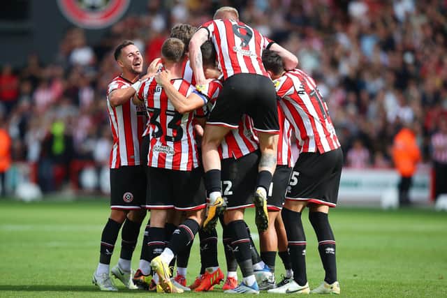 Oliver Norwood of Sheffield United is mobbed by celebrating teammates after scoring against Blackburn Rovers: Lexy Ilsley / Sportimage