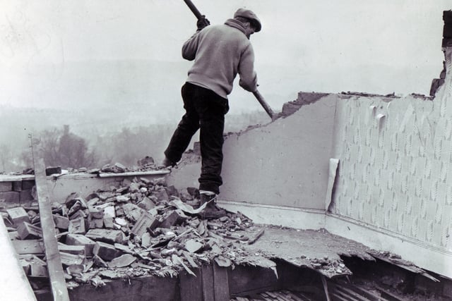 A workman starts demolition work at Brightside Vicarage in Firth Park Avenue, Sheffield, where Shirley Margaret Hill, wife of the vicar, the Rev Colin Hill, was killed during the hurricane of February 16, 1962. The vicarage was so badly damaged it was beyond repair