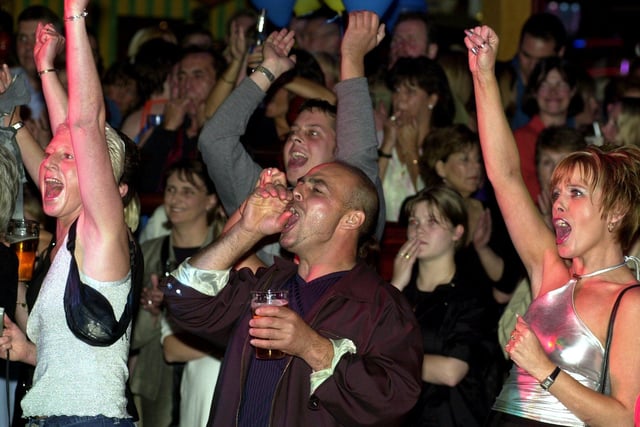 The crowd at Brannigans Bar in Valley Centertainment, Sheffield, cheer on Stars in their Eyes-style talent contest winners Ray Drury (Joe Cocker) and Debra Porter (Jennifer Warnes) in 2000
