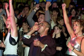 The crowd at Brannigans Bar in Valley Centertainment, Sheffield, cheer on Stars in their Eyes-style talent contest winners Ray Drury (Joe Cocker) and Debra Porter (Jennifer Warnes) in 2000