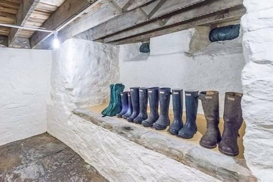 The property has a boot room - stairs lead down to a utility room and cellars.
