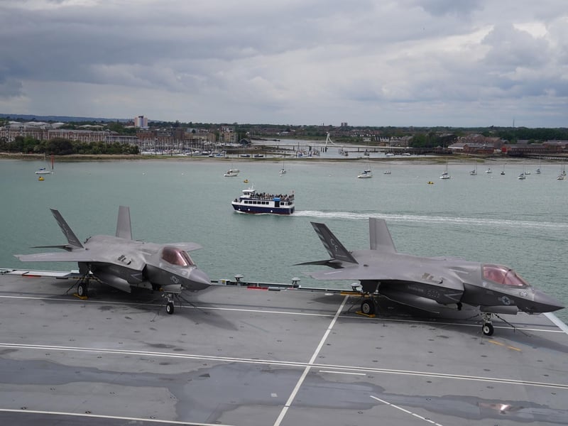 A pair of F-35B Lightning II jets on the flight deck during Queen Elizabeth II's visit to HMS Queen Elizabeth at HM Naval Base, Portsmouth, ahead of the ship's maiden deployment. The visit comes as HMS Queen Elizabeth prepares to lead the UK Carrier Strike Group on a 28-week operational deployment travelling over 26,000 nautical miles from the Mediterranean to the Philippine Sea. Picture date: Saturday May 22, 2021. PA Photo. See PA story ROYAL Carrier. Photo credit should read: Steve Parsons/PA Wire