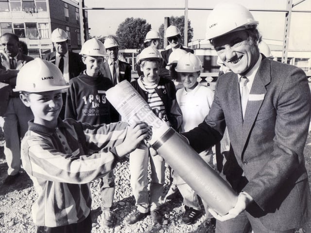 Alan Milton (13) a pupil at Waltheof School, places a copy of the Star newspaper in the time capsule held by Coun Peter Price, Leisure Chairman