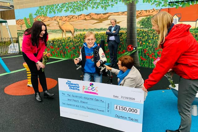 Tobias and his mum, with representatives of Paces and Sheffield Children’s Hospital, receiving the cheque at Paces School this morning.