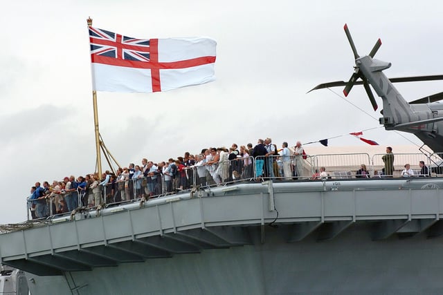 Enjoying the view! Hundreds of members of the public on the aft of the flight deck on HMS Illustrious watching one of the many public displays going on in the water below in the Navy Base. Picture: Malcolm Wells 053125-130