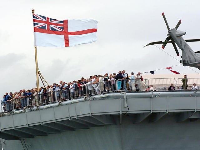 Enjoying the view! Hundreds of members of the public on the aft of the flight deck on HMS Illustrious watching one of the many public displays going on in the water below in the Navy Base. Picture: Malcolm Wells 053125-130